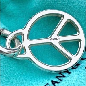 Tiffany & Co Peace Sign Charm (retired design) with Tiffany Pouch.
